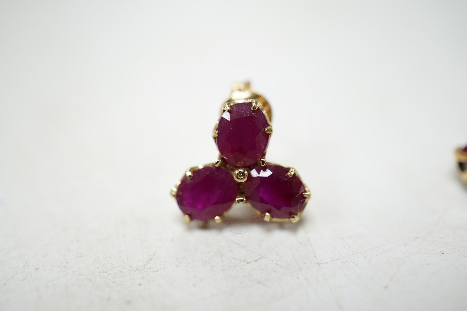 A modern pair of 9ct gold and three stone ruby cluster set ear studs, 9mm, gross weight 1.6 grams. Condition - good